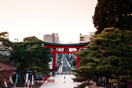 DEC 2, 2018 Iwate, Japan - Grand Red Torii gate at Morioka Hachimangu Shrine in Iwate prefecture at sunset with warm tone sky - Tohoku region beautiful landscape and cityのeditorial素材