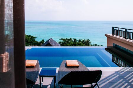 Modern luxury Infinity edge pool with wide seaview tropical island resort villa with pool bedの写真素材