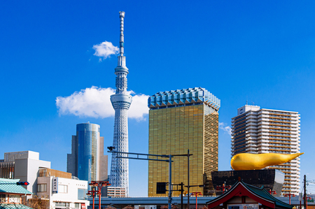 NOV 29, 2018 Tokyo, Japan - Tokyo Skytree Tower rised high against blue sky with Asahi Beer Hall in winter shot from Asakusa area, Japan famous modern landmark and cityscapeのeditorial素材