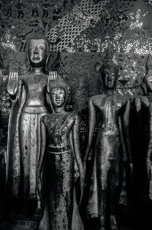 Antique old wooden Buddha statues at Wat  Xieng thong museum.  Most Famous tourist attraction in side World heritage zoneのeditorial素材