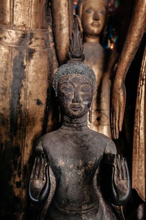 Luang Prabang, Laos - Antique old wooden and gold Buddha statues at Wat  Xieng thong museum.  Most Famous tourist attractionのeditorial素材