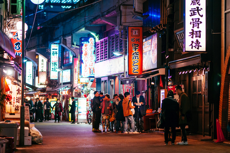 Tokyo, Japan - Ameyoko market vibrant busy food street night life in Ueno district with many light box signs, tourists and Japanese peopleのeditorial素材
