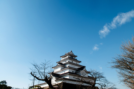 DEC 4, 2018 Aizu Wakamatsu, JAPAN - Aizu Wakamatsu Tsuruga Castle and tree under winter blue sky. Fukushima Samurai lord fortess in Edo periodのeditorial素材