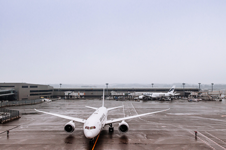DEC 6, 2018 Narita, Japan -  Airplane during raining bad weather at Tokyo Narita International airport passenger terminalのeditorial素材