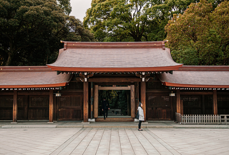 DEC 5, 2018 Tokyo, Japan - Meiji Jingu Shrine Historic Wooden gate and corridor with tourists and forest background - Most important shrine of Japan capital city.のeditorial素材