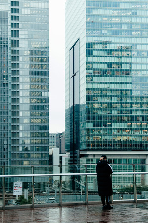DEC 6, 2019 Tokyo, JAPAN - Marunouchi District modern office buildings tourist enjoys Tokyo downtown cityscape in evening. View from Kitte building observatory deck.のeditorial素材