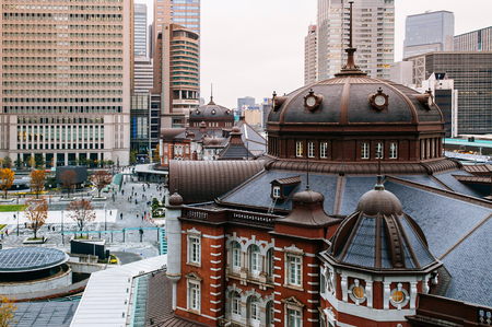 Tokyo Station old heritage red brick building Marunouchi district with modern office towers in backgroundのeditorial素材