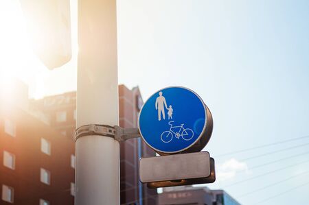 Blue Crosswalk pedestrian crossing sign against sunlight sky with copy space on one sideの写真素材