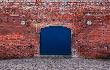 Blue iron gate with red brick wall old rustic industrial loft retro vintage warehouse wallの素材 [FY310132353067]