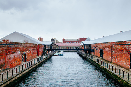 DEC 1, 2018 Hakkodate, Japan -  Hakkodate Red brick warehouses Kanemori and canal at Hakodate port in winter season foggy atmosphereのeditorial素材