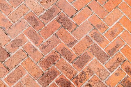 Old red brick texture background, diagonal herringbone brick pattern retro grungy wallpaperの写真素材