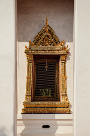 OCT 24, 2019 Bangkok, Thailand - Bangkok National Museum golden carved wood window frame of front palace throne hall under sunlight.のeditorial素材