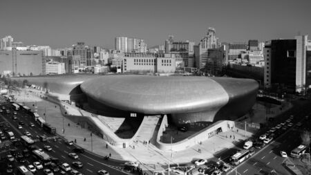 DEC 11, 2015 Seoul, South Korea - Dongdaemun design plaza or DDP modern free from building architecture in black and white arial view with busy traffic on streetのeditorial素材