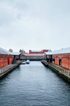 DEC 1, 2018 Hakkodate, Japan -  Hakkodate Red brick warehouses Kanemori and canal at Hakodate port in winter season foggy atmosphereのeditorial素材
