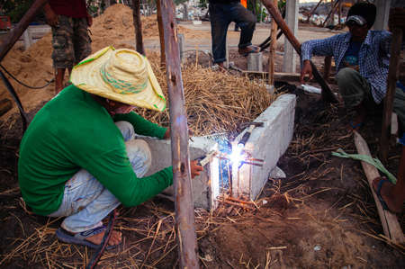 MAY 8, 2010 Bangkok, Thailand - Asian male construction labour do metal welding work with bright...
