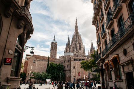 OCT 27, 2012 Bearcelona, Spain - Old ancient Cathedral of Barcelona, Spain. with many tourists at Placita De La Seu under warm light in the afternoonのeditorial素材