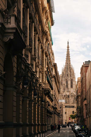 OCT 27, 2012 Bearcelona, Spain - Old ancient Cathedral of Barcelona, Spain. with tourists at small...
