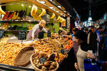 OCT 27, 2012 Bearcelona, Spain - Fresh mushroom shop and buyers at Mercado de La Boqueria food market on La Rambla streetのeditorial素材