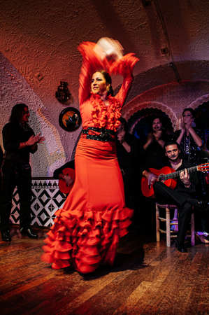 OCT 28, 2012 Barcelona, Spain - Sexy and beautiful red dress lady in Flamenco dance with fast movement blury image. Cultural dance of Andalusia in Spainのeditorial素材
