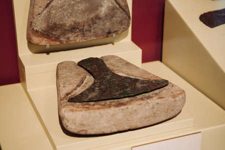 JAN 12, 2019 Udon Thani, Thailand - Ancient weapons bronze axe in its mold prehistory human tools exhibits at Ban Chiang Museumのeditorial素材
