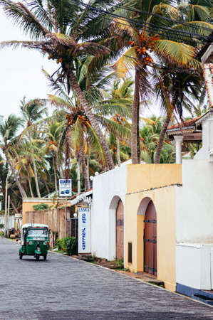 JUL 3, 2012 Galle, Sri Lanka - Galle city old town with Dutch colonial buildings in small alley with motor tricyclesのeditorial素材