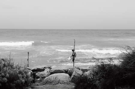 Jul 3, 2012 Weligama, Galle, Sri Lanka - Stilt Fishing, skillfully southern Sri Lanka fishing culture. Fisherman sit on wood pole and fishing in high wave sea.のeditorial素材