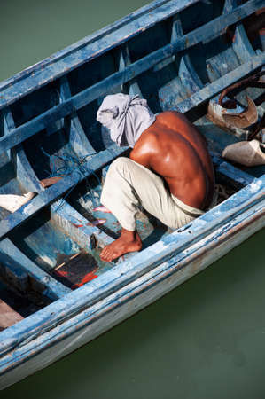 JUN 5, 2010 Phuket, Thailand - Local Fisherman with beautiful tanned skin in longtail fishing boat at Chalong bayのeditorial素材