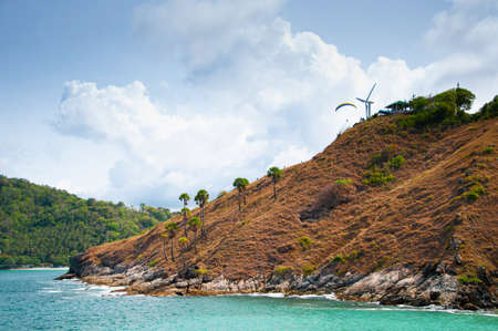 Golden grass cape and blue sea under blue sky with white clouds at Yanui beach in phuket. Thailandの写真素材