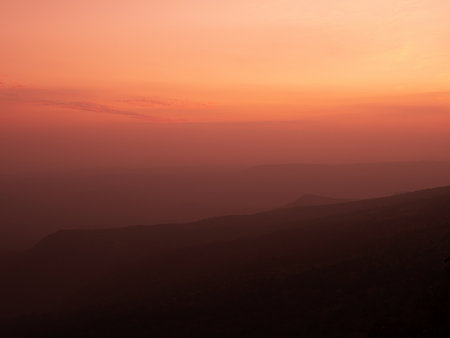 Beautiful charming dramatic sunset gradient shade mountain landscape of Phu Kradueng National park.の写真素材