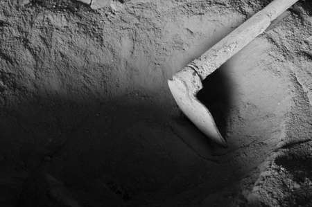 Manual Concrete powder mix with old hoe in the dark