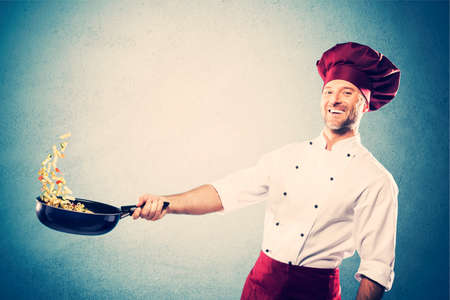 Chef cooking pasta on a skilletの写真素材