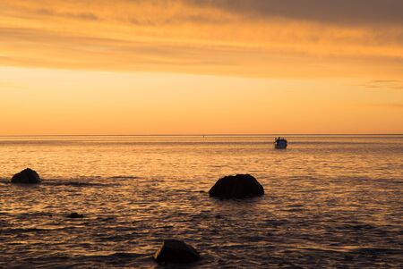 Sunset at Hallet Cove, South Australia with a boat and rocksの写真素材