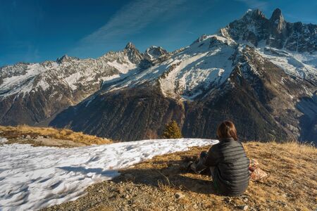 Rear view of girl relaxing in nature on a mountain
