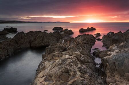 Sunset over a rocky beach in hallet cove. SAの写真素材