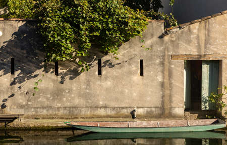 A close up shot of a door and a boat docked in front of itの写真素材