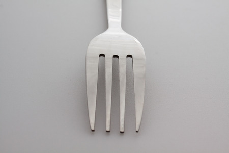 a silver fork  isolated on gray background