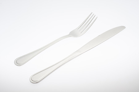 a silver fork with knife isolated on white backgroundの写真素材