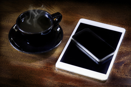 Business concept still life Morning Coffee Cup with smartphoneの写真素材