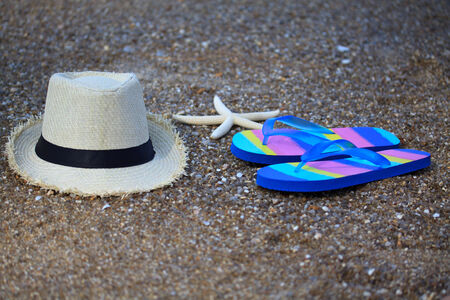 Summer straw hat with slippers and star fishの写真素材
