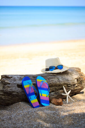 Summer straw hat with slippers and star fishの写真素材