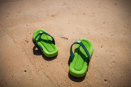 slippers with hat on the beachの写真素材