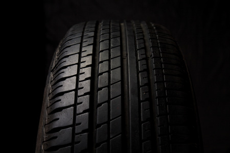 Car tires close-up on black backgroundの写真素材