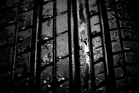 Car tires close-up on black background
