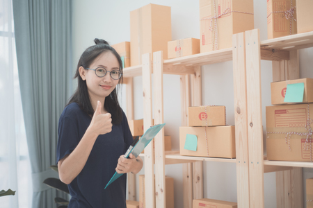 Young Asian Woman Working at home, Young business start up online seller owner,  Delivery Project, Woman with Online Business or SME Concept.の写真素材