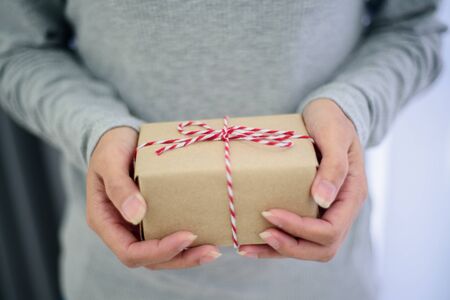 Closed up of woman hands with gift box.の写真素材