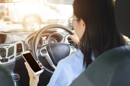 Asian woman driving car with  feeling happy.