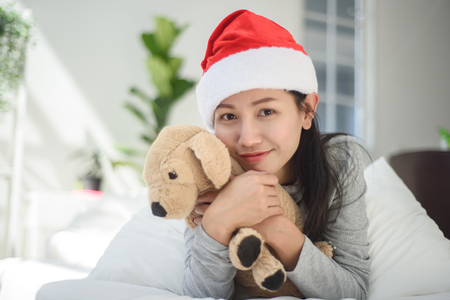 Asian woman with gift box on white background.の写真素材