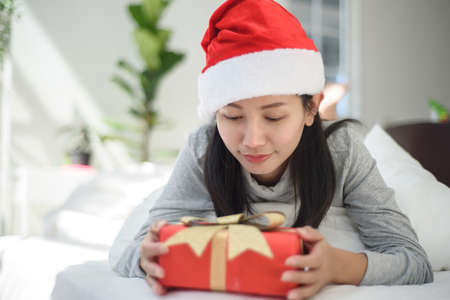 Asian woman with gift box on white background.の写真素材