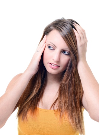 Young unhappy woman with severe headache holding forehead in painの写真素材