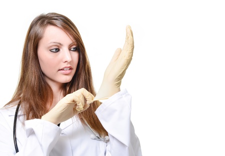 Pretty female doctor is putting protective gloveの写真素材